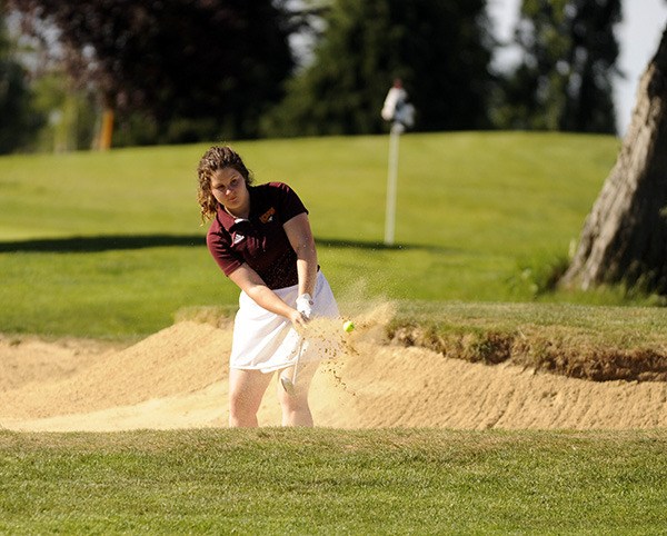 Madison Gale of Kingston High School gets out of a bunker during the Olympic League Golf Tournament