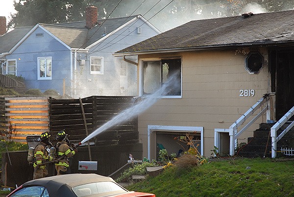 Firefighters spray water into a Bremerton home Nov. 24.