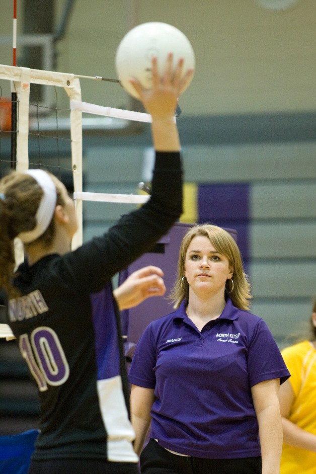 Assistant coach Tara Curtis helps a player practice her kills before a match against Sequim High on Oct. 5.