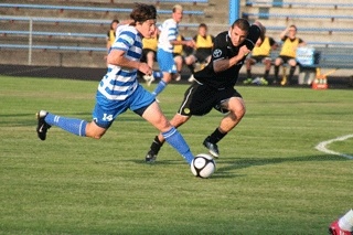 Kitsap Pumas forward Stephen Phillips races past a Portland defender during the Pumas' 3-0 loss in the first round of the U.S. Open Cup Tuesday night at Memorial Stadium.