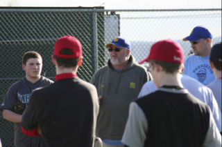 (Above) Bremerton baseball coach Ken Plowman (center) talks to his team — and a few aspiring players — during a tryout at Legion Field in Bremerton Tuesday. (Below) More than 30 players turned out for BHS’ baseball tryouts. Plowman said he’d keep about 15 on the varsity team.