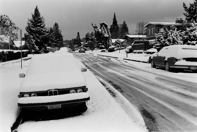 A parked BMW is nearly camouflaged by fallen snow in Port Angeles in this 2011 file photo.