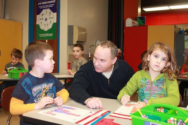Burley Glenwood Elementary School principal Darek Grant overlooks the work of kindergartners earlier this week. Grant's school recently was recognized as one of only three elementary schools in the state to be acknowledged as a Title I