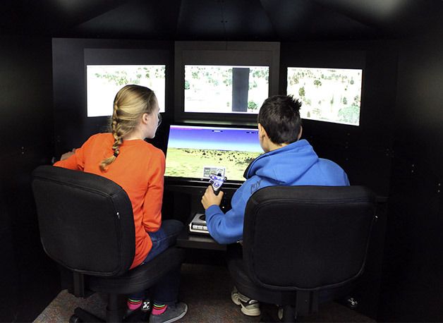 Central Kitsap Junior High students Molly Fischer and Fred Beckson work together on a flight simulator mission. The pair are taking an ACE (Aviation Classroom Experience) class as an elective during its pilot phase.