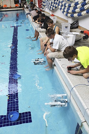Central Kitsap Junior High students test out their ROVs during a power energy transportation class. The students worked in pairs and were required to solder