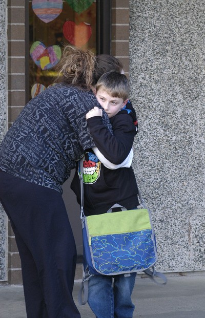 An Armin Jahr third grader gets a hug from his mom after being released by the school following the shooting of a classmate. The Bremerton School District said a fellow student shot a third grader just minutes before school let out.