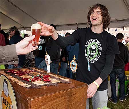 A patron of the 2010 Bremerton Summer BrewFest receives a beer from one of the many booths. This year's BrewFest will showcase 23 Washington breweries and more than 60 different beers.