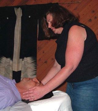 Reiki master Anne Quade treats a patient.