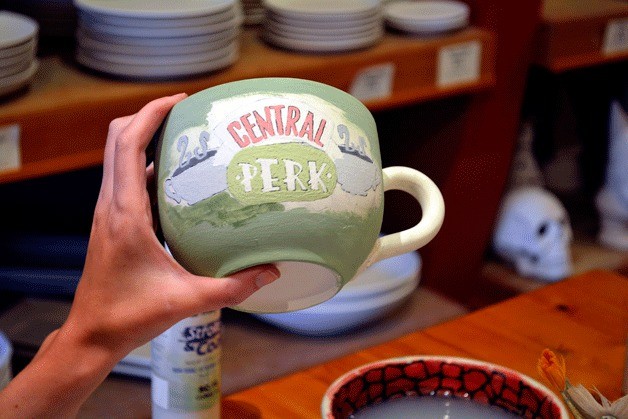 A 'Friends' Central Perk/Slytherin coffee mug in process of being painted at Dancing Brush in downtown Poulsbo.