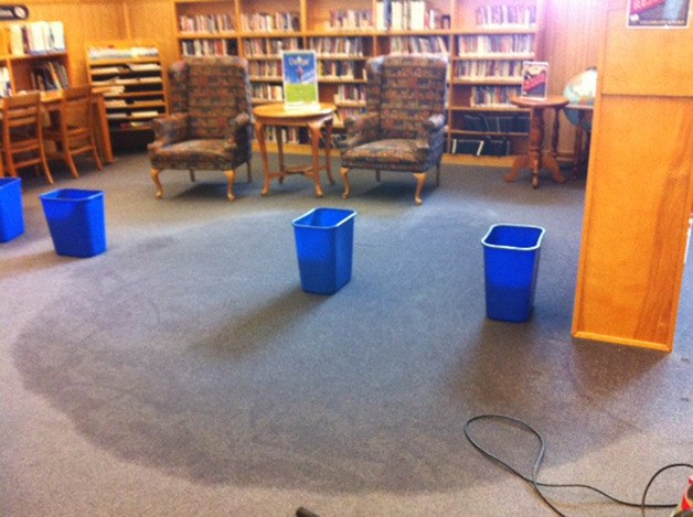 Wastebaskets are placed to collect water dripping from the ceiling of the Port Orchard Library. Water from snow melting on top of the building’s flat roof leaked through in several places.