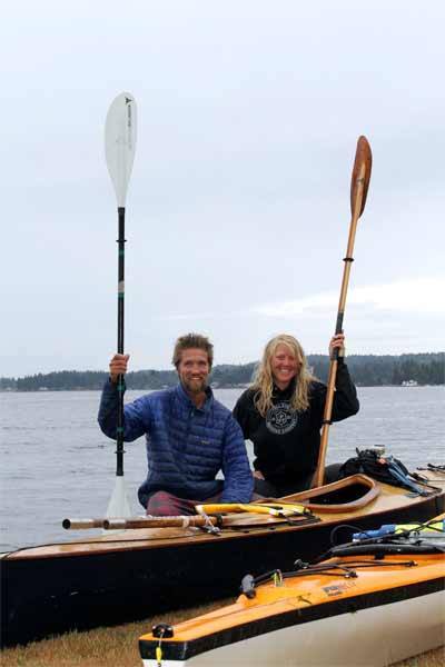 Benjamin Young and Brianna Shepard pose in front of the kayaks they used to travel from Juneau