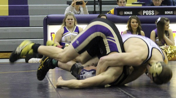 North Kitsap’s Jake Velarde pins Sequim’s Brett Wright Jan. 23 during the meet against the Sequim Wolves. Velarde is competing for his fourth state wrestling title.