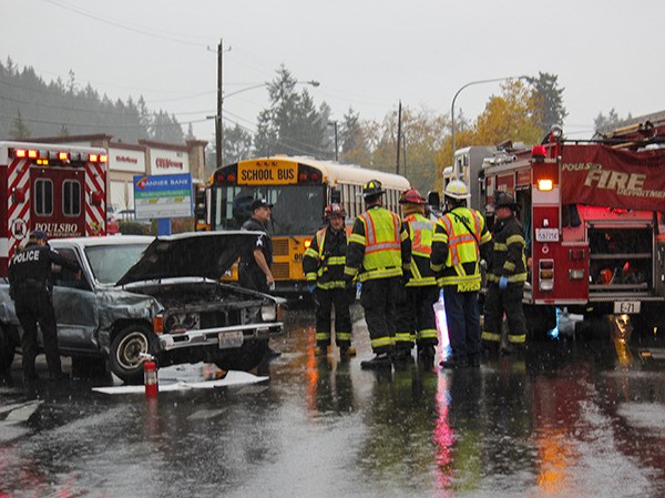 Poulsbo Fire Department and Poulsbo Police investigate the scene of a collision between a NKSD school bus and a Toyota pickup Oct. 26.