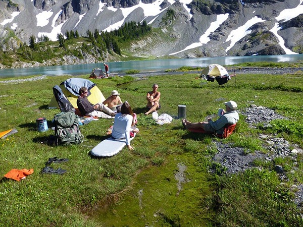 Members of the Peninsula Wilderness Club relax lakeside during a recent outing. The club does a range of outdoor recreational activities year-round.