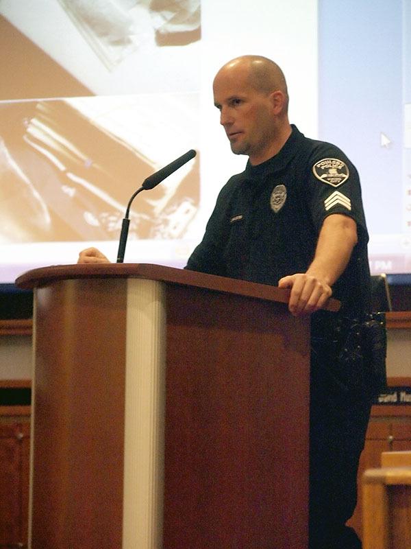 Poulsbo Police Sgt. John Halsted speaks with Poulsbo residents about block watches and the work he has done with the Bremerton SOG.