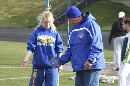 Former Bremerton High School track coach Lloyd Pugh talks with an athlete in 2009.