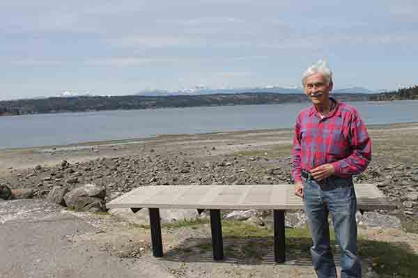 Ted Hilliard stands next to the park bench that has been added to the Tracyton dock.