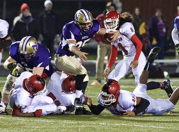 The Renton Indians' defense crumbles as the North Kitsap Vikings drive their way down the field Nov. 8 at North Kitsap Stadium during the 2A District playoffs. The Vikings won 27-6 and advance to the first round of the State tournament.