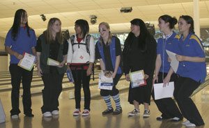 Bowlers who rolled 200 series in Oly League play this year crouch down to accommodate Olys Liza Ambrose (white shirt). The group included three Knights.
