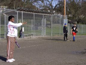 New Bremerton fastpitch coach Octavia Spann gives instructions to her players during drills at practice on Tuesday. Spann is hoping the team can bounce back from a turbulent 2007 that included seeing the team fold midseason.