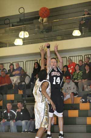 Central Kitsap guard Cody Thurmond fires off a three-pointer during CKs loss to Decatur Tuesday. Right