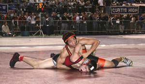 Central Kitsap 140-pound senior Franco Cruz checks the clock during his 16-5 victory against Kentlakes Austin Carrillo Friday at Mat Classic.