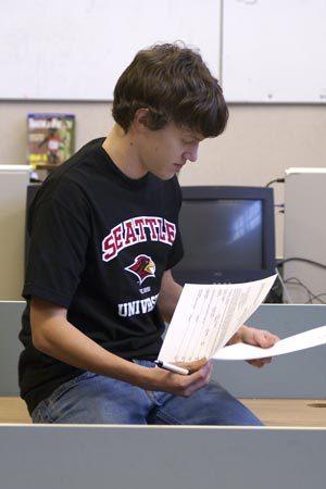 Central Kitsap cross country and track and field runner Rustin Winger signs his letter of intent for Seattle University last week.