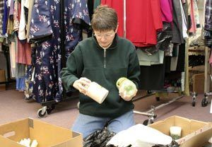 Discovery Shop volunteer Lindsy Ingram sorts through Christmas items the shop couldnt sell during its flood-induced December closure. The shop plans to donate the items to the Association of Retarded Citizens (ARC) in Bremerton.