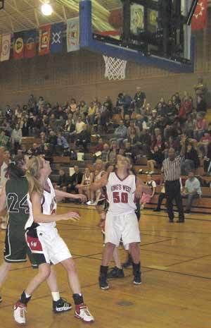 Kings Wests Megan Morris and Hayley Milleson box out for a rebound in last Saturdays 52-41 district title win against Shoreline Christian.