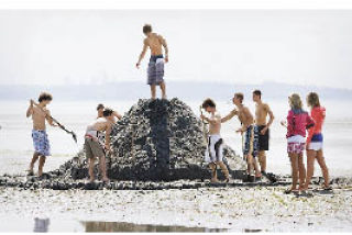 Where to begin? This group of sculptors gets ready to shape the sand during the Indianola sand-sculpture contest Aug. 2.