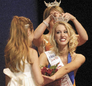Newly named Miss Kitsap Samantha Przybylek reaches for a hug from her pageant Little Sister Kiana Cheyney as former Miss Kitsap Megan Hornbuckle crowns Przybylek at Saturday’s event. The 2005 Klahowya Secondary School grad is currently attending Olympic College.