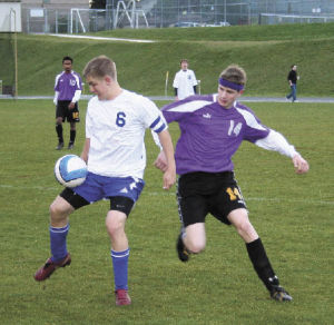 Bremerton’s Richie Danskin tries to control the ball while a Sequim defender applies pressure in Tuesday’s 5-3 win against the Wolves.