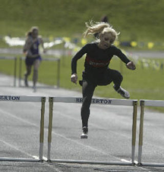 King’s West’s Irene Moore clears a hurdle earlier this season at the Kitsap County Classic.