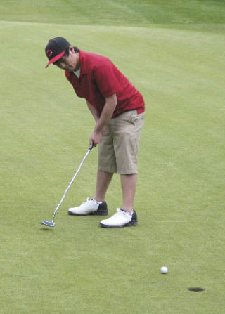Bremerton golfer Doug Tran tries to sink a put at the Olympic League tournament Monday at McCormick Woods in Port Orchard. Tran just missed qualifying.
