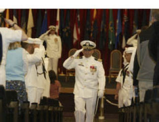 Outgoing Naval Base Kitsap Capt. Reid Tanaka salutes as he exits the change of command ceremony at Naval Base Kitsap-Bangor Wednesday. He will now serve as chief of staff with Carrier Strike Group Five aboard the USS George Washington in Yokosuka