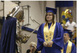 Bremerton High School senior Samantha Graziano gets knighted before walking across the stage to receive her diploma during graduation June 13.