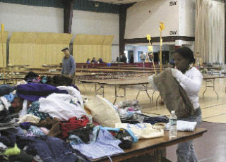 Victoria Carter with the USS Emory S. Land volunteered Monday morning to help sort items donated for the 11th annual RAGS (Rotary Auction Garage Sale) taking place Saturday