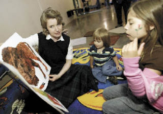 Kitsap Regional Library Silverdale Branch Librarian Amanda Cane reads the book “From Head To Toe” to children at Thursday’s third annual Central Kitsap Family Night.