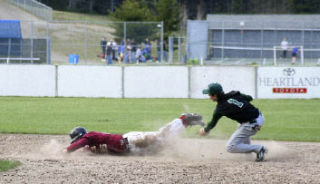 Kingston’s Theron Rahier tries an unconventional slide into second base as Klahowya’s Brandon Neet attempts to make the tag Friday.