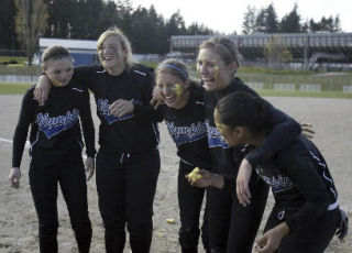 Oly’s five seniors pose for a shot after smothering each other with cupcakes Thursday.