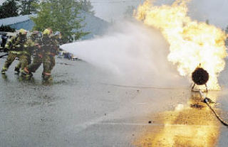 Local firefighters extinguish a controlled fire to the amazement of last year’s Kids’ Day crowd. Firefighters will do live fire demonstrations and vehicle extrications at this year’s Kids’ Day as well.