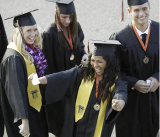 Central Kitsap High School seniors Alyssa Bergsma (far left) and Andrew Buskirk can only laugh as Jerika Gonzalez busts a move before entering the Pavilion at the Kitsap County Fairgrounds for graduation Thursday.