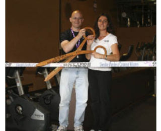 Anytime Fitness owners Dr. Chris and Jackie Carr cut the ceremonial ribbon at their grand opening on Thursday.
