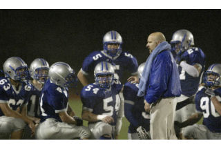 Olympic coach Eric Allen talks to his team following a 34-20 loss against Timberline Oct. 3. The Trojans (0-5) looked to win their first game of the season last night against Yelm. Results were unavailable at press time.
