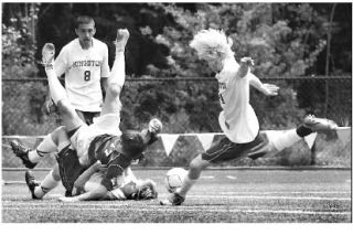 Kingston’s Ian Chaussee tumbles to the ground with a Sehome defender and clears the shot path for  John Troka.