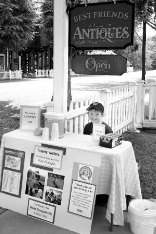 Tommy Walters sets up his lemonade stand on Wednesday afternoon in front of Best Friends Antiques in Port Gamble. He’s raising money for his trip to Akron