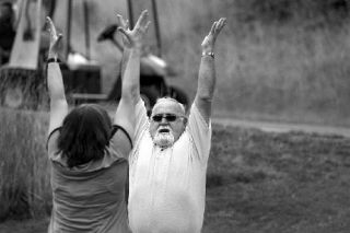 Golfer Loren Belton from Team Embarq gets a little yoga stretching lesson prior to last year’s Poulsbo Chamber Golf Classic at Gold Mountain Golf Complex. This year’s golf tournament is on July 24.