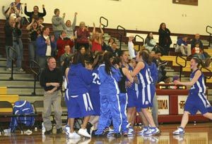 Olympic guard Pepper Fanua lets out a yell while getting mobbed by her teammates after sinking two free throws with just 1.9 seconds left to lift the Trojans to a 43-32 district win on Saturday. Fanua led Oly with 16 points.