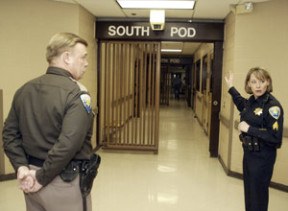 Sgt. Sauni Holt leads a group into South Pod at Kitsap County Jail as Deputy Scott Wilson looks on.