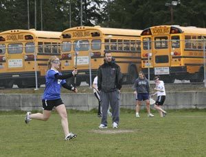 Klahowya girls lacrosse coach Eric Moore directs his players in passing drills at practice Thursday at Central Kitsap Junior High.